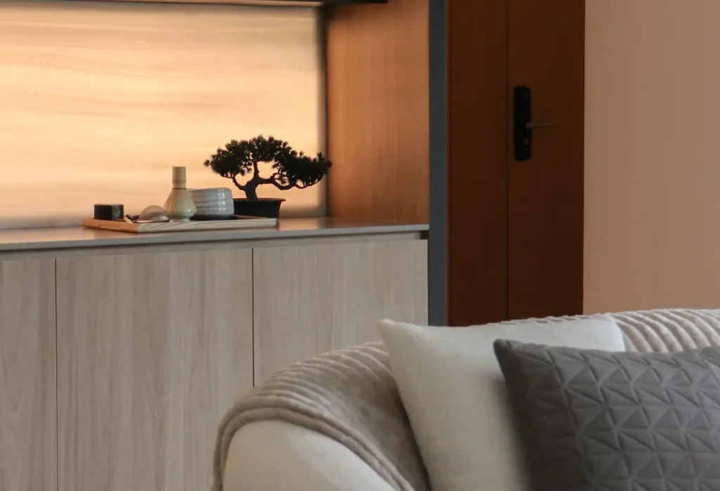 furnish with a clean-lined sofa in neutral tones. keep accessories minimal, add textured fabrics like linen or wool, and use soft, warm lighting to create an inviting, relaxed atmosphere.